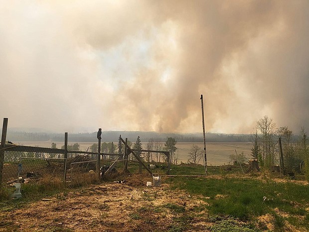 Smoke rises as fire singes Fort Nelson on May 14.
Mandatory Credit:	Cheyenne Berreault/Anadolu/Getty Images via CNN Newsource