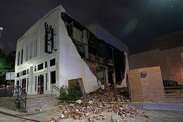 Felled bricks spill from a building after a severe thunderstorm hit downtown Houston on May 16.
Mandatory Credit:	David J. Phillip/AP via CNN Newsource