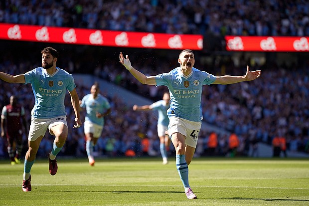 Phil Foden celebrates after scoring the opening goal for Manchester City.
Mandatory Credit:	Dave Thompson/AP via CNN Newsource