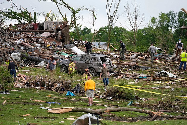 Residents and first responders survey the remains of tornado-ravaged homes in Greenfield, Iowa, on Tuesday.
Mandatory Credit:	Charlie Neibergall/AP via CNN Newsource