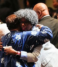 Mourners greet one another as they pay their respects for The Rev. William “Bill” Lawson in the sanctuary of the original Wheeler Avenue Baptist Church on Thursday, May 23, 2024, in Houston. Known for being a “Houston’s Pastor,” Lawson was the founding pastor of Wheeler Avenue Baptist Church who helped lead the Houston’s racial desegregation in the 1960s and continued to be a civil rights leader and spiritual guide throughout his life. He retired from the pulpit in 2004, but remained active in the church until his death on May 14 at age 95.