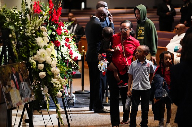 Mourners pass by flowers and images of Rev. William “Bill” Lawson in the sanctuary of the original Wheeler Avenue Baptist Church on Thursday, May 23, 2024, in Houston. Known for being a “Houston’s Pastor,” Lawson was the founding pastor of Wheeler Avenue Baptist Church who helped lead the Houston’s racial desegregation in the 1960s and continued to be a civil rights leader and spiritual guide throughout his life. He retired from the pulpit in 2004, but remained active in the church until his death on May 14 at age 95.