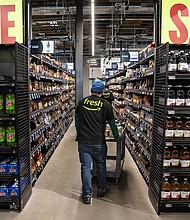 Workers stock shelves at an Amazon Fresh grocery store in Seattle, Washington, on May 2.
Mandatory Credit:	David Ryder/Bloomberg/Getty Images via CNN Newsource