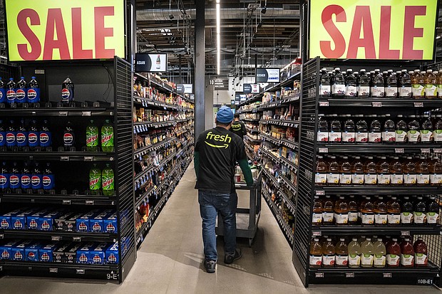 Workers stock shelves at an Amazon Fresh grocery store in Seattle, Washington, on May 2.
Mandatory Credit:	David Ryder/Bloomberg/Getty Images via CNN Newsource