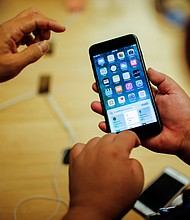 Customers take a look at the new iPhone 7 smartphone inside the Apple Inc. store in New York, in 2016.
Mandatory Credit:	Eduardo Munoz/Reuters via CNN Newsource