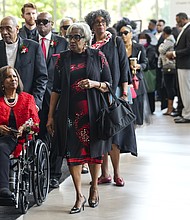 Family members, including daughter Melanie Lawson, in red, make their way to the sanctuary at Wheeler Avenue Baptist Church for the celebration of life services for The Rev. William “Bill” Lawson in the sanctuary of on Friday, May 24, 2024 in Houston. Known for being a “Houston’s Pastor,” Lawson was the founding pastor of Wheeler Avenue Baptist Church who helped lead the Houston’s racial desegregation in the 1960s and continued to be a civil rights leader and spiritual guide throughout his life. He retired from the pulpit in 2004, but remained active in the church until his death on May 14 at age 95.