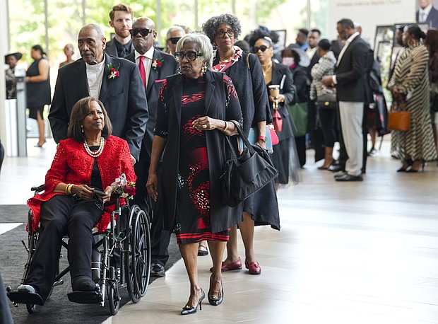 Family members, including daughter Melanie Lawson, in red, make their way to the sanctuary at Wheeler Avenue Baptist Church for the celebration of life services for The Rev. William “Bill” Lawson in the sanctuary of on Friday, May 24, 2024 in Houston. Known for being a “Houston’s Pastor,” Lawson was the founding pastor of Wheeler Avenue Baptist Church who helped lead the Houston’s racial desegregation in the 1960s and continued to be a civil rights leader and spiritual guide throughout his life. He retired from the pulpit in 2004, but remained active in the church until his death on May 14 at age 95.