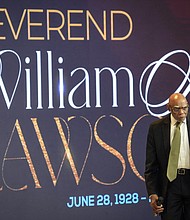 Dr. James Douglas walks onto the pulpit to speak during the celebration of life services for The Rev. William “Bill” Lawson on Friday, May 24, 2024 in Houston. Known for being a “Houston’s Pastor,” Lawson was the founding pastor of Wheeler Avenue Baptist Church who helped lead the Houston’s racial desegregation in the 1960s and continued to be a civil rights leader and spiritual guide throughout his life. He retired from the pulpit in 2004, but remained active in the church until his death on May 14 at age 95.