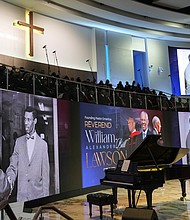 Historic photos are shown during a video tribute for The Rev. William “Bill” Lawson on Friday, May 24, 2024 in Houston. Known for being a “Houston’s Pastor,” Lawson was the founding pastor of Wheeler Avenue Baptist Church who helped lead the Houston’s racial desegregation in the 1960s and continued to be a civil rights leader and spiritual guide throughout his life. He retired from the pulpit in 2004, but remained active in the church until his death on May 14 at age 95.