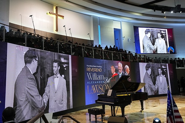 Historic photos are shown during a video tribute for The Rev. William “Bill” Lawson on Friday, May 24, 2024 in Houston. Known for being a “Houston’s Pastor,” Lawson was the founding pastor of Wheeler Avenue Baptist Church who helped lead the Houston’s racial desegregation in the 1960s and continued to be a civil rights leader and spiritual guide throughout his life. He retired from the pulpit in 2004, but remained active in the church until his death on May 14 at age 95.