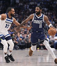 Irving (right) scored 14 of his 33 points in the fourth quarter against the Timberwolves.
Mandatory Credit:	Julio Cortez/AP via CNN Newsource