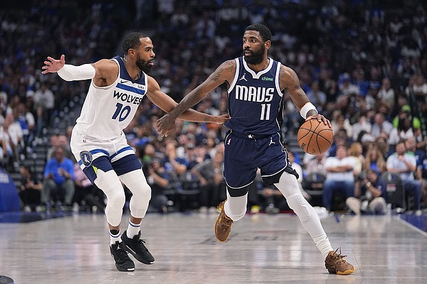 Irving (right) scored 14 of his 33 points in the fourth quarter against the Timberwolves.
Mandatory Credit:	Julio Cortez/AP via CNN Newsource