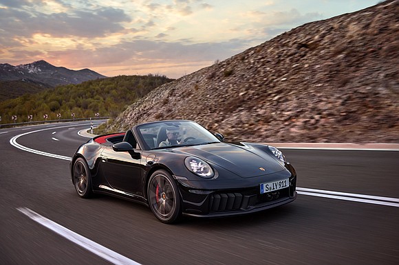 Porsche unveiled the first hybrid version of its most famous sports car, the 911, on Tuesday, a move that could …