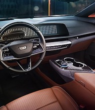 View of the 2025 Cadillac OPTIQ interior in Autumn Canyon, featuring the 33-inch-diagonal interface and display with 9K resolution.