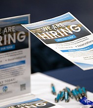 A job hunter takes a flyer at a job fair at Brunswick Community College in Bolivia, North Carolina, on April 11. The number of job openings in the US shrank for the second month in a row.
Mandatory Credit:	Allison Joyce/Bloomberg/Getty Images via CNN Newsource