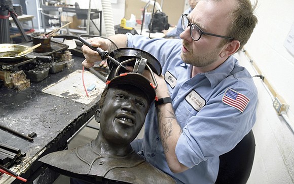 As he coats a mold of Jackie Robinson with wax, metalsmith Alex Haines reflected on the extra importance of a …