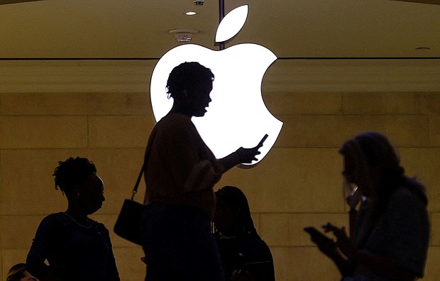 A woman uses an iPhone at the Apple store at Grand Central Terminal in New York City. Apple is widely expected to announce a partnership with ChatGPT maker OpenAI.
Mandatory Credit: