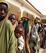 Girls rescued by Nigerian soldiers from Islamist militants Boko Haram at Sambisa Forest line up to collect donated clothes at the Malkohi refugee camp in Yola in May 2015.
Mandatory Credit:	Emmanuel Arewa/AFP/Getty Images via CNN Newsource