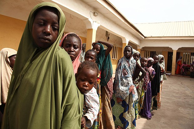 Girls rescued by Nigerian soldiers from Islamist militants Boko Haram at Sambisa Forest line up to collect donated clothes at the Malkohi refugee camp in Yola in May 2015.
Mandatory Credit:	Emmanuel Arewa/AFP/Getty Images via CNN Newsource