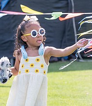 Stylish 4-year-old Charleigh Clarke plays with ribbons June 15 before the fun begins at Henrico County’s annual Juneteenth celebration in Dorey Park.