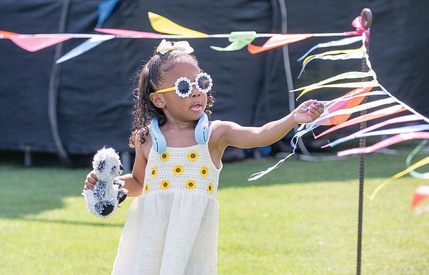 Stylish 4-year-old Charleigh Clarke plays with ribbons June 15 before the fun begins at Henrico County’s annual Juneteenth celebration in Dorey Park.