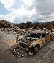 A car sits charred Saturday near the remains of the Swiss Chalet Hotel after both were destroyed by the South Fork Fire in the mountain village of Ruidoso, New Mexico.
Mandatory Credit:	Andres Leighton/AP via CNN Newsource