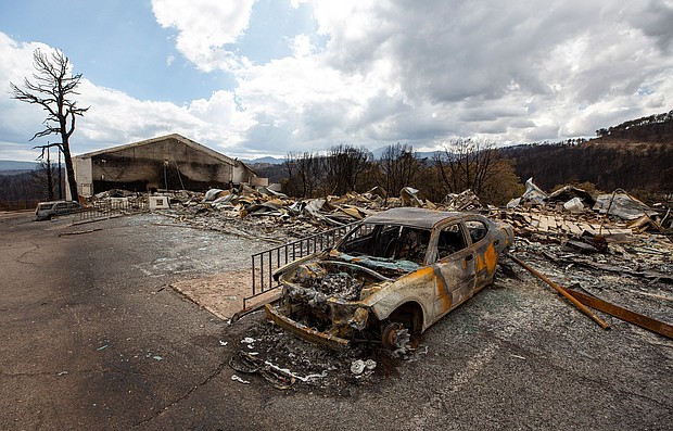 A car sits charred Saturday near the remains of the Swiss Chalet Hotel after both were destroyed by the South Fork Fire in the mountain village of Ruidoso, New Mexico.
Mandatory Credit:	Andres Leighton/AP via CNN Newsource