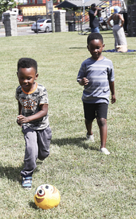 Who needs music when you’ve got a smiling ball? While grown-ups groove at Virginia Union University’s Juneteenth celebration held Saturday, June 15, 4-year-old Must Washington and 5-year-old Kin Taylor turn the Barco-Stevens Hall lawn into their personal playground.