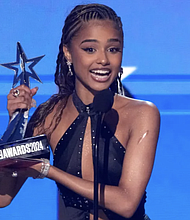 Tyla accepts accepts the award for best international act during the BET Awards on Sunday, June 30, 2024, at the Peacock Theater in Los Angeles. Chris Pizzello/Invision/AP