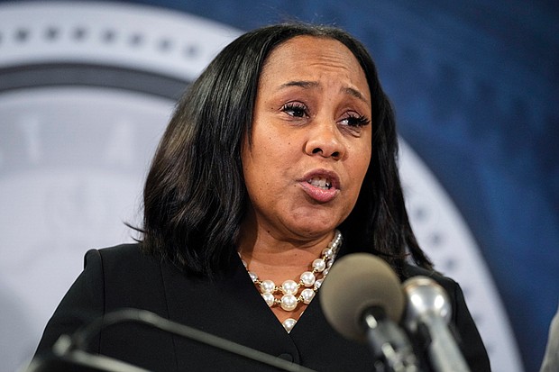 Fulton County District Attorney Fani Willis speaks during a news conference, Aug. 14, 2023, in Atlanta. People connected with former President Donald Trump’s legal cases have been inundated with threats. In Atlanta, Willis, who brought criminal charges against Trump and 18 other people alleging they schemed to illegally overturn the 2020 election results in Georgia, is known to be accompanied by round-the-clock bodyguards.