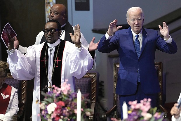 President Biden, right, and Dr. J. Louis Felton worship at a church service at Mt. Airy Church of God in Christ, Sunday, July 7, in Philadelphia.