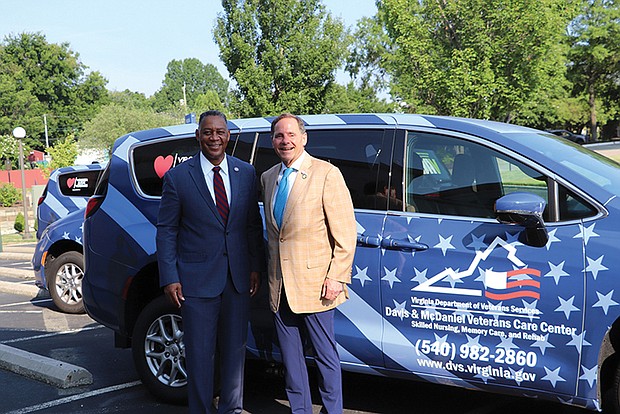 Virginia Secretary of Veterans and Defense Affairs Craig Crenshaw, left, and DVS Commissioner Chuck Zingler standing with one of the donated vans.