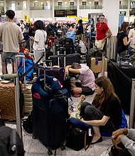 Passengers wait at Gatwick Airport amid a global IT outage on July 19 in Crawley, United Kingdom.
Mandatory Credit:	Jack Taylor/Getty Images via CNN Newsource