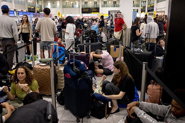 Passengers wait at Gatwick Airport amid a global IT outage on July 19 in Crawley, United Kingdom.
Mandatory Credit:	Jack Taylor/Getty Images via CNN Newsource