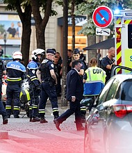 Police stand next to an ambulance after an officer was injured in an attack next to the Champs-Elysees avenue, in Paris, France July 18, 2024.
Mandatory Credit:	Kevin Coombs/Reuters via CNN Newsource