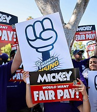 Workers gather with signs as the Teamsters union and Disney cast members demand fair wages at a rally outside Disneyland, in Anaheim, California, in July 17.
Mandatory Credit:	David Swanson/Reuters via CNN Newsource