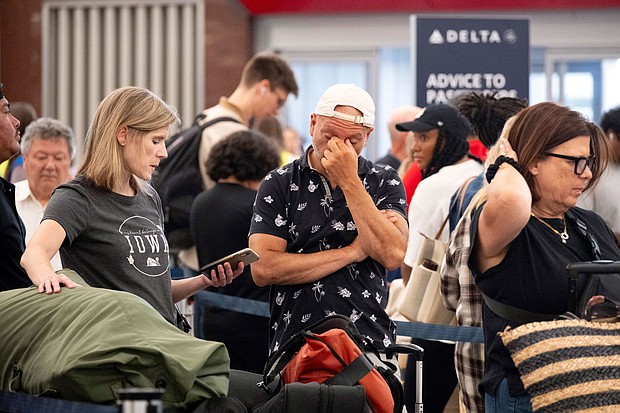 Passengers try to rebook their flight to Iowa at Hartsfield Jackson International Airport in Atlanta on Friday amid the major tech outage.
Mandatory Credit:	Ben Gray/AP via CNN Newsource