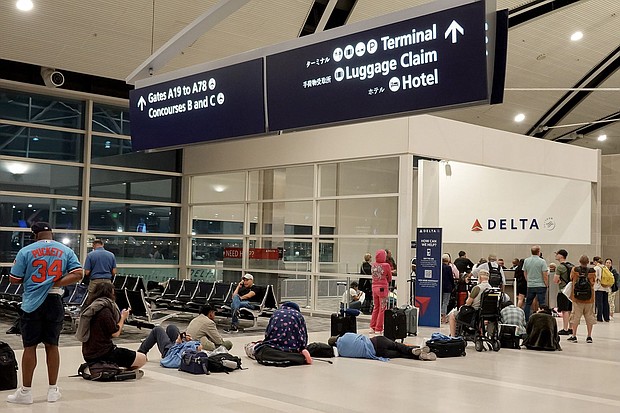 Travelers wait in a long line to speak with a Delta representative at the help desk in the McNamara terminal at the Detroit Metropolitan Wayne County Airport on July 20 in Detroit, Michigan.
Mandatory Credit:	Joe Raedle/Getty Images via CNN Newsource