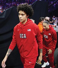 Brittney Griner, left, Diana Taurasi, and Chelsea Gray, of Team USA, walk on the court July 20 prior to a WNBA All-Star basketball game against Team WNBA in Phoenix.