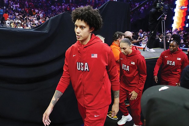 Brittney Griner, left, Diana Taurasi, and Chelsea Gray, of Team USA, walk on the court July 20 prior to a WNBA All-Star basketball game against Team WNBA in Phoenix.
