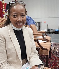 The Rev. Dorothy Sanders Wells, a native of Mobile, Ala., sits on a stage at St. Andrew’s Episcopal School Campus in Ridgeland, Miss., Friday, July 19, before being formally installed as the first woman and first black person to hold the post of bishop of the Episcopal Diocese of Mississippi.