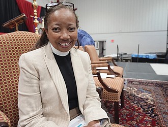 The Rev. Dorothy Sanders Wells, a native of Mobile, Ala., sits on a stage at St. Andrew’s Episcopal School Campus in Ridgeland, Miss., Friday, July 19, before being formally installed as the first woman and first black person to hold the post of bishop of the Episcopal Diocese of Mississippi.