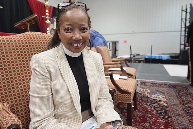 The Rev. Dorothy Sanders Wells, a native of Mobile, Ala., sits on a stage at St. Andrew’s Episcopal School Campus in Ridgeland, Miss., Friday, July 19, before being formally installed as the first woman and first black person to hold the post of bishop of the Episcopal Diocese of Mississippi.