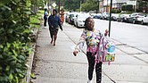 An excited Cynthia Matthews, a fourth-grader at Woodville Elementary School, arrives for her first day back Monday as a part of the RPS200 program. She is steps ahead of her mother, Angelica Blackman, who brought her to school.