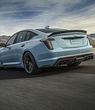 Rear view of the 2025 Cadillac CT5-V Blackwing Precision Package in Drift Metallic driving on-track.