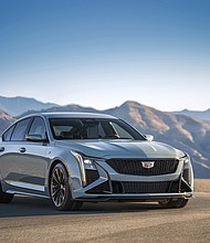 Front 3/4 view of the 2025 CT5-V Blackwing in Drift Metallic with the sky and mountains in the background.