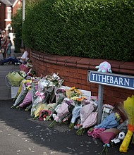 Tributes to the victims are left by wellwishers on July 30, in Southport, England after a teenager armed with a knife attacked children at a Taylor Swift-themed holiday club in Hart Lane, Southport.
Mandatory Credit:	Christopher Furlong/Getty Images via CNN Newsource