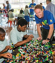 Preben Elnef, program lead for Lego Manufacturing Virginia, lends a hand to North Side Club members.