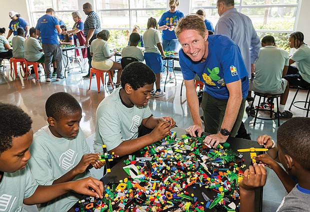 Preben Elnef, program lead for Lego Manufacturing Virginia, lends a hand to North Side Club members.