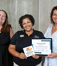 Autism Society of Central Virginia Executive Director Ann Flippin, left, Science Museum Community Engagement Coordinator Cherita Paul and Autism Society of Central Virginia Community Engagement Director Debra Holloway.